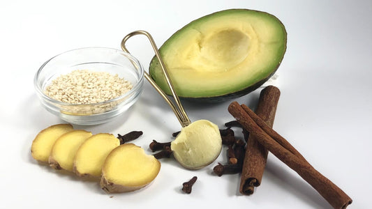 A clean hand warming two drops of face oil before pressing it into freshly cleansed, damp skin prior to makeup.