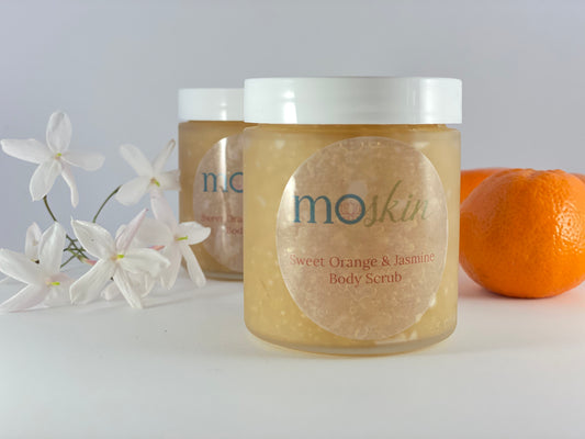 A sunlit bathroom scene with a sugar body scrub, a soft towel, and a small dab of body butter ready for a light, warm‑weather ritual.